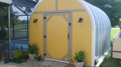steel S model storage shed with custom yellow front endwall with walk through door and pool house next to it