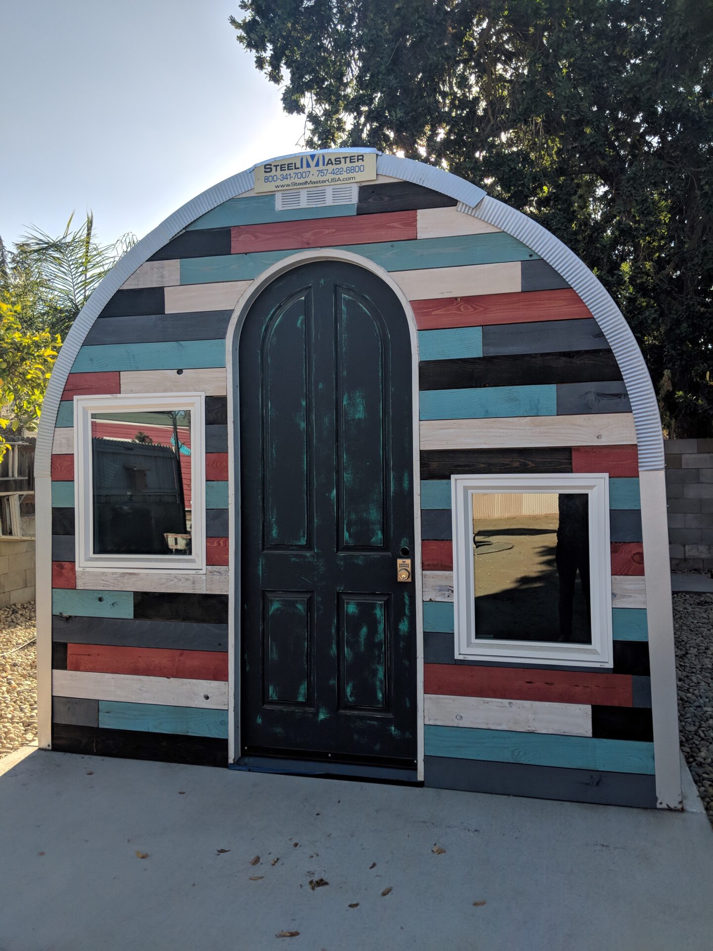 steel S model storage shed with custom front endwall that is different color panels and custom walk through door