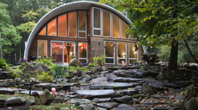 Q-Model Quonset home with a recessed custom end wall and several custom windows