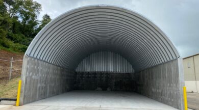 arch steel roof mounted on concrete walls and solid back endwall empty inside