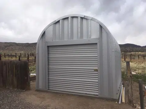 Fire resistant Quonset blacksmith workshop, steel endwall, and rolling door.