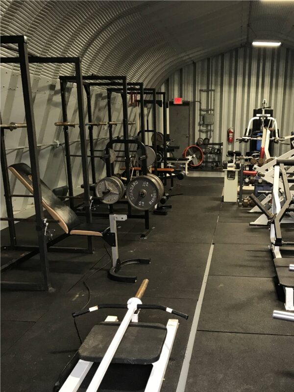 interior of x model steel building used for a gym with gym equipment inside