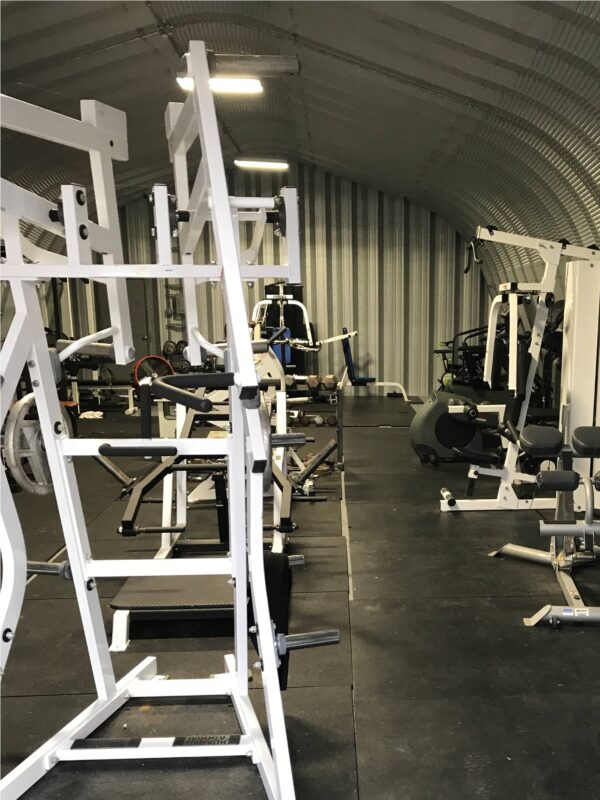 interior of x model steel building used for a gym with gym equipment inside