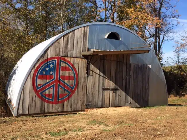 Q-Model Quonset hut with custom end wall with American peace sign