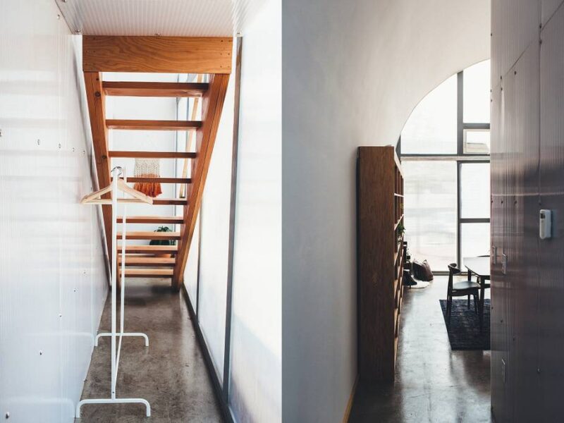 Inside a Quonset home: views from the side- stairway to loft with underneath storage (left) and narrow hallway (right).