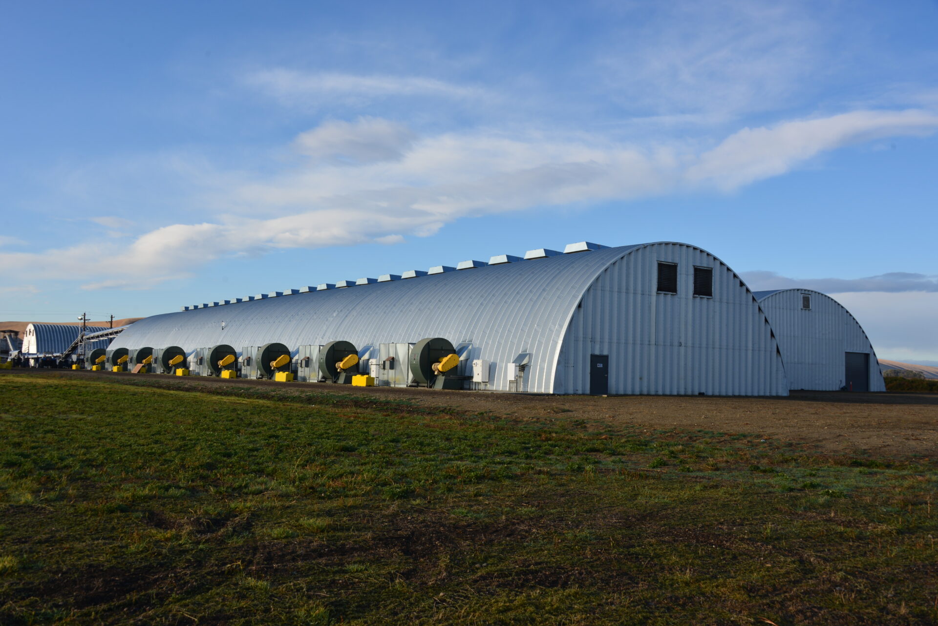 very large multiple steel Q model steel arch style buildings with vents and steel endwalls