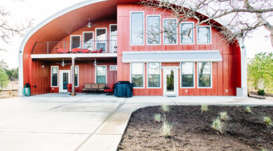 S-Model Quonset home with custom red front end wall