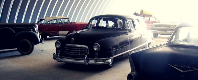 interior of antique car storage building with cars inside