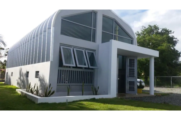quonset house mounted on concrete walls, custom endwall with glass, awning over entrance
