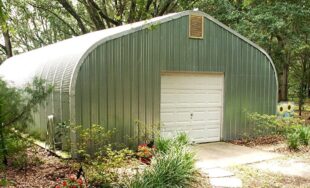 A-model Quonset hut with walkway, garden, and vent on the top of the end wall.
