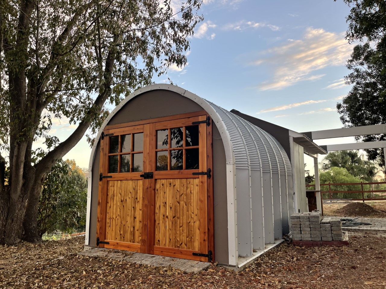 steel S model storage shed with custom front grey endwall with beautiful wood and glass double walk through doors