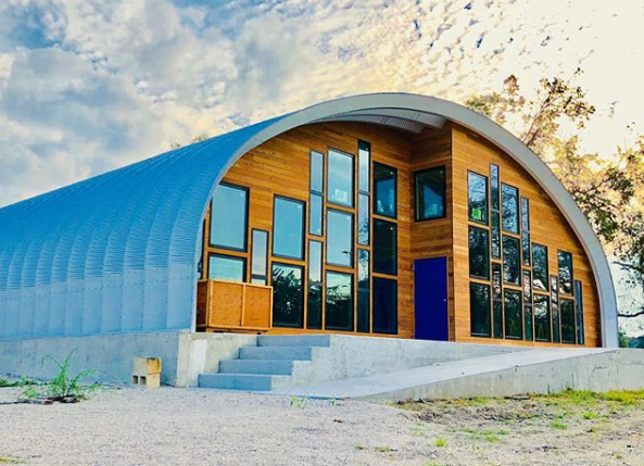 S-Model Quonset hut with custom wood end wall with windows