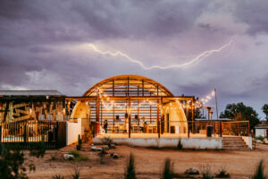 Quonset hut pavilion with lightning in the backgound