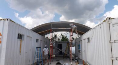 People on scaffolding building the clinic in a can