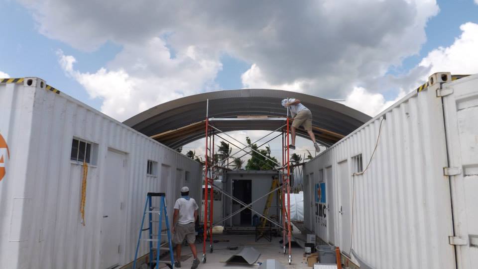 People on scaffolding building the clinic in a can