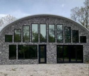 exterior of steel quonset home with custom endwalls and windows