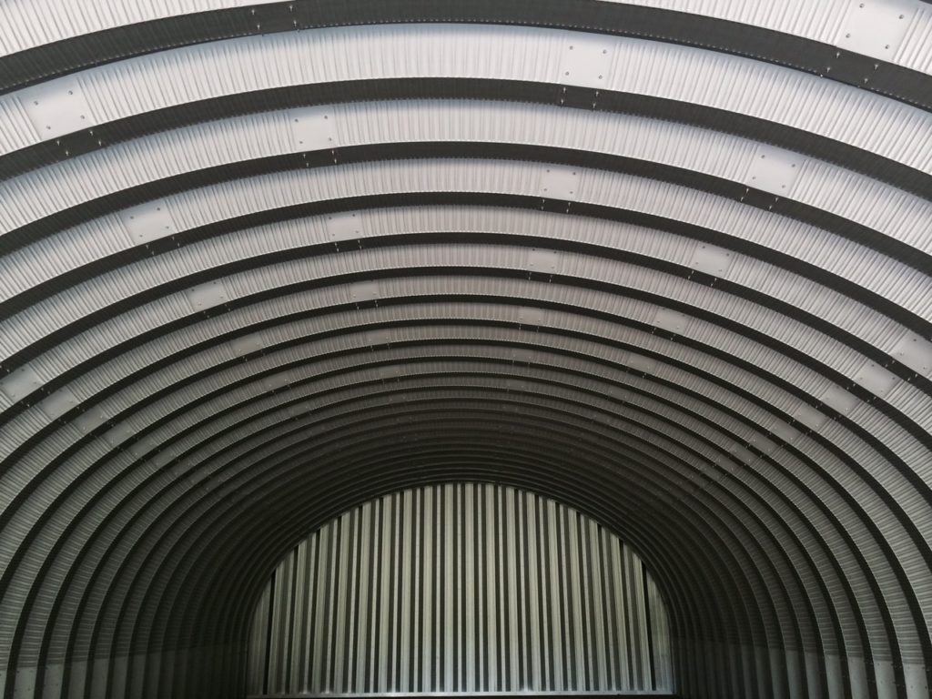 Metal arches and endwall inside Quonset hut