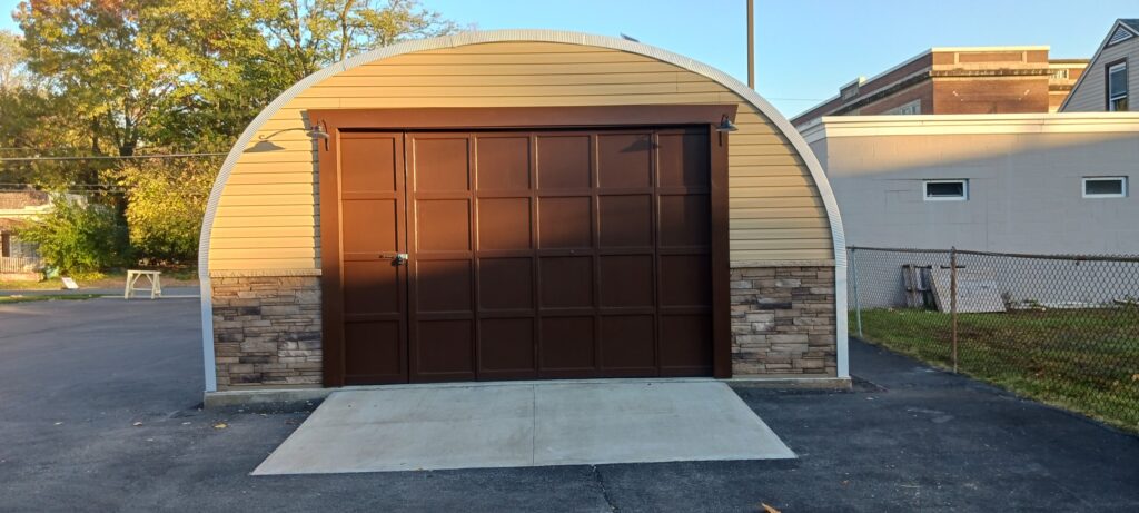 S-model quonset garage, custom panel and stone endwall, dark brown garage door