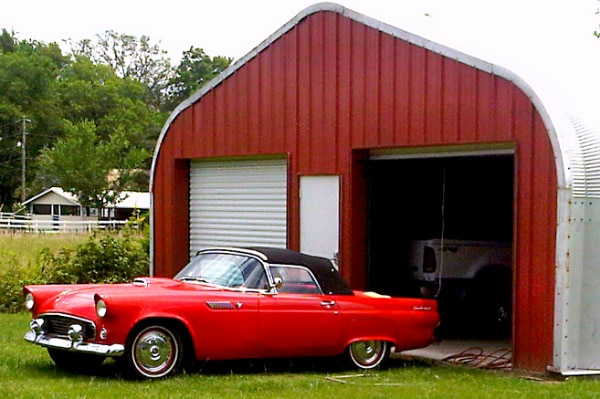 A-Model Quonset hut with red vintage car in front