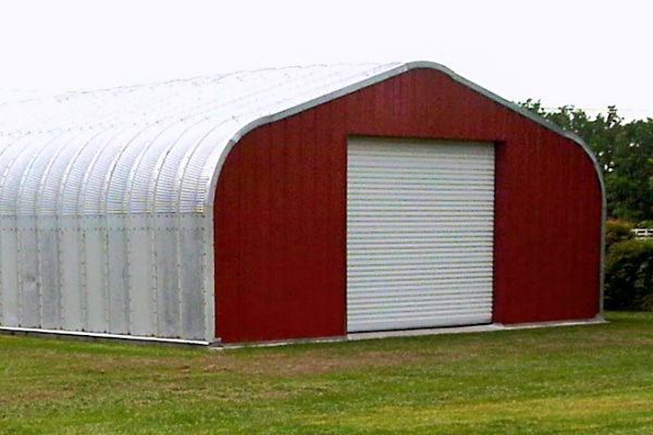 A-Model Quonset hut with custom red end wall and white garage door