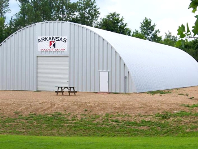 steel quonset building with front entrance and white rolling door