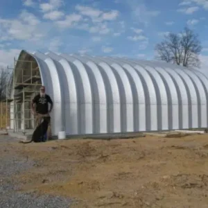 Charles B. standing in front of his unfinished building