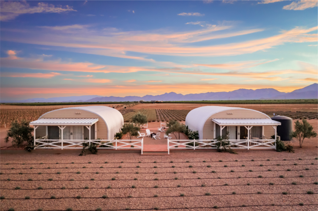 Two s-model quonset homes in Arizona desert during a sunset