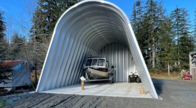 One open-ended X-Model Quonset hut with boat inside