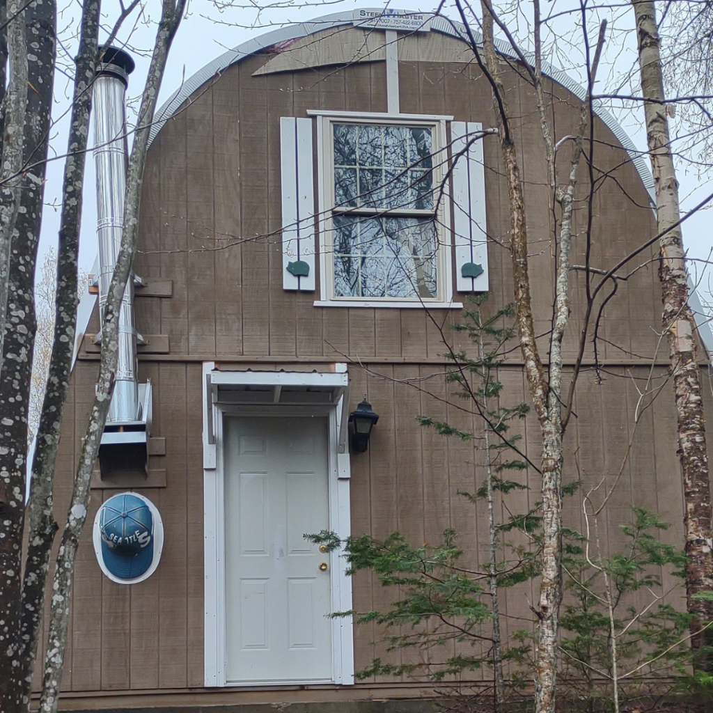 z-model brown endwall quonset structure, white front door and upper window