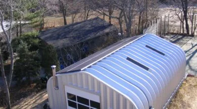 A-Model Quonset with steel endwalls, skylights, and a vent pipe on the endwall