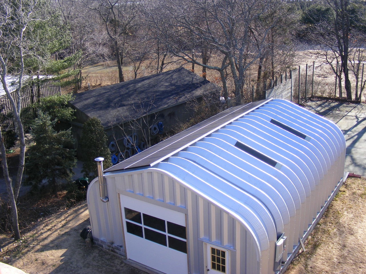 A-Model Quonset with steel endwalls, skylights, and a vent pipe on the endwall