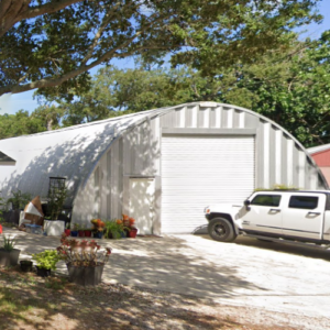 Q-Model Quonset Hut garage with white truck parked out front